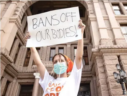  ?? JAY JANNER/AUSTIN AMERICAN-STATESMAN VIA AP ?? A woman in Austin protests a Texas law that bans most abortions after a fetal heartbeat can be detected.