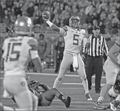  ?? The Associated Press ?? 5B
Florida State quarterbac­k Jameis Winston (5) launches this pass toward intended receiver Travis Rudolph (15) against Louisville Thursday in Louisville, Ky. The No. 2 Seminoles overcame a 21-0 first-half deficit to win 42-31.