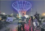  ?? SONU MEHTA/HT PHOTO ?? Visitors take selfies at Central Park where the Delhi government is organising a community Diwali with laser shows.
