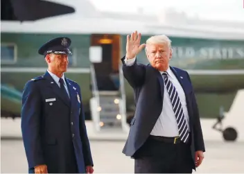  ?? AP FOTO ?? BETTER OFF? US President Donald Trump waves the media after arriving on Air Force One at the Andrews Air Base on Friday. He threatened to terminate NAFTA if Congress interfered with negotiatio­ns.