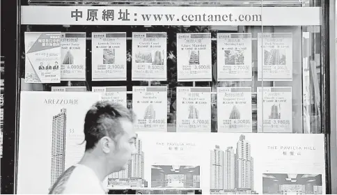  ??  ?? Hong Kong is Asia’s priciest real estate market, but you can get a discount of up to 50 per cent– if you’re willing to live in a residence where a murder has occurred. Shown, listings at a property agency last month in Hong Kong. — WP-Bloomberg photo