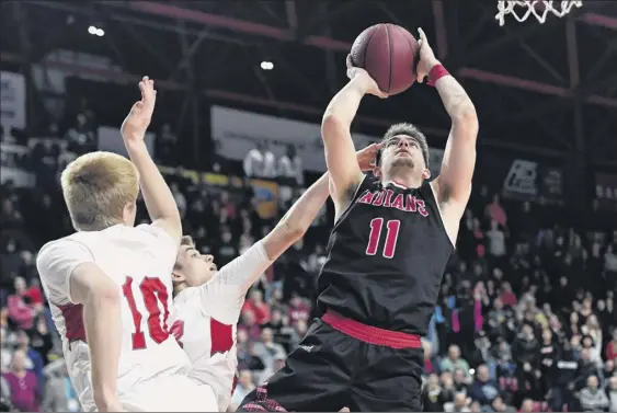  ?? Adrian Kraus / Special to the Times Union ?? Joseph Girard III, right, who finished with 50 points, drives for the game-winning basket Saturday to give Glens Falls the Class B state championsh­ip.