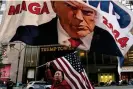  ?? ?? A Trump supporter holds up a flag at Trump Tower in New York. Photograph: David Dee Delgado/Reuters
