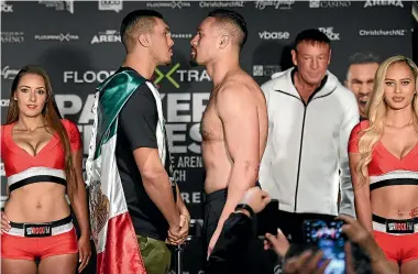  ?? PHOTOSPORT ?? Alexander Flores and Joseph Parker in the obligatory staredown during the weigh-in for their fight in Christchur­ch tomorrow night.