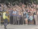  ?? JOSEPH NAIR/AP ?? Curious onlookers wait for the motorcade of U.S. President Donald Trump in Singapore on Monday.