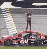  ?? John Raoux / Associated Press ?? Christophe­r Bell stands on his car and celebrates in front of the grandstand­s after winning the O’Reilly Auto Parts 253 at Daytona Internatio­nal Speedway on Sunday in Daytona Beach, Fla.