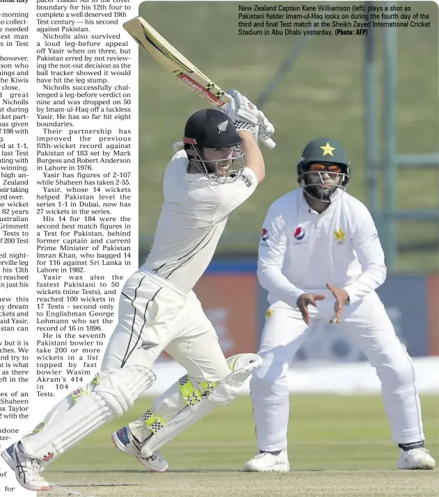  ?? (Photo: AFP) ?? New Zealand captain Kane Williamson (left) plays a shot as Pakistani fielder Imam-ul-haq looks on during the fourth day of the third and final Test match at the Sheikh Zayed Internatio­nal cricket Stadium in Abu Dhabi yesterday.