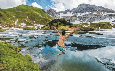  ?? FOTO: RALF LIENERT ?? BWL-Student Alex Keller wagt nach einer Wanderung den Sprung in den eisigen Schrecksee bei Hinterstei­n in den Allgäuer Alpen.