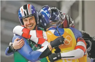  ?? ANDY WONG/THE ASSOCIATED PRESS ?? Chris Mazdzer, left, is congratula­ted after their team luge run Thursday at the 2018 Winter Olympics in Pyeongchan­g, South Korea.