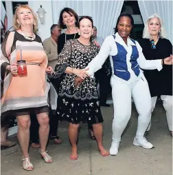  ??  ?? Girls just wanna have fun. And that’s exactly what (from left) Ginny Knight, Cathy Rollins (mother of bride), Altheia Jackson (Silver Birds Steel Orchestra), and Susan Zises Green are doing at the rehearsal dinner.