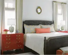  ??  ?? Nightstand­s painted deep coral feel fresh in the master bedroom.