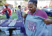  ?? CURTIS COMPTON/ CCOMPTON@ AJC. COM ?? Chellita Carlyle buys a “Straight Outta Paine” T- shirt at a spirit event this month at Paine College in Augusta. The student body might be smaller than in years past, but the students are proud.