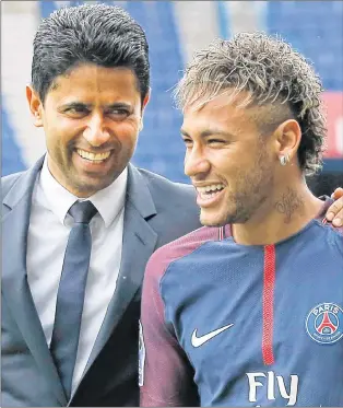  ?? AP PHOTO ?? Brazilian soccer star Neymar walks away with the chairman of Paris Saint-germain Nasser Al-khelaifi, left, following a press conference in Paris Friday, Aug. 4, 2017. Neymar arrived in Paris on Friday the day after he became the most expensive player...