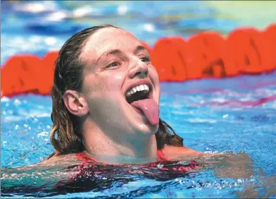  ?? TIBOR ILLYES / MTI VIA AP ?? Katinka Hosszu of host Hungary reacts after winning the women's 200m individual medley final at the World Aquatics Championsh­ips in Budapest on Monday.