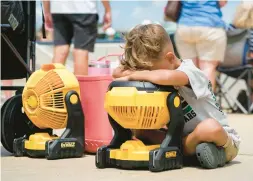  ?? GERALD HERBERT/AP ?? Braxton Hicks, 7, of Livingston, Texas, cools off during a heat wave that occurred during a baseball tournament in Ruston, Louisiana, earlier this month.