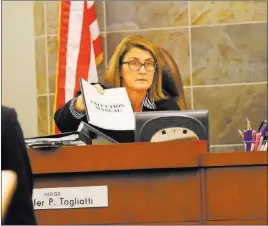  ?? Michael Quine ?? Las Vegas Review-journal @Vegas88s District Judge Jennifer Togliatti holds the execution manual during a Nov. 8 hearing at the Regional Justice Center.