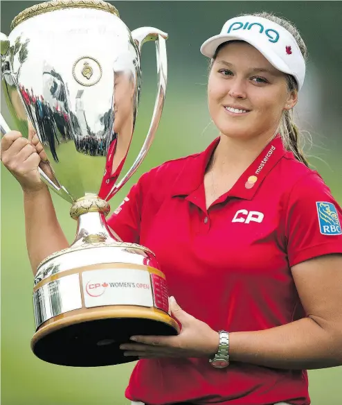  ?? TROY FLEECE / POSTMEDIA NEWS ?? Brooke Henderson of Smiths Falls, Ont., hoisted the championsh­ip trophy in August at the Wascana Country Club in Regina after becoming the first homegrown Canadian since 1973 to capture the LPGA CP Women’s Open. Henderson is this year’s Postmedia Female Athlete of the Year for the third time in four years.