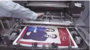  ?? AP PHOTO/NASSER NASSER ?? A Jordanian specialist follows the process of printing posters with pictures of Crown Prince Hussein and his fiancée, Saudi architect Rajwa Alseif, on Wednesday at a print house in Amman, Jordan. The poster reads “We celebrate Hussein.”