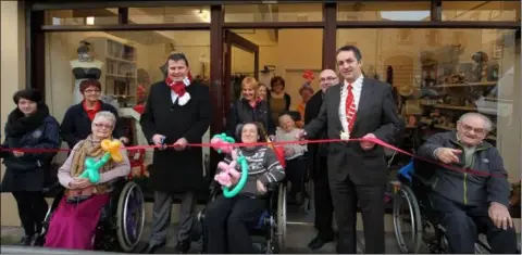  ??  ?? Robbie Horgan and Richie Culhane help to open the IWA shop