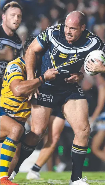  ?? Picture: IAN HITCHCOCK/GETTY IMAGES ?? North Queensland’s Matt Scott takes a hard hit-up against Parramatta