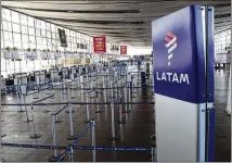  ?? ESTEBAN FELIX / ASSOCIATED PRESS ?? The check-in area for South America’s biggest passenger carrier, Latam Airlines, is empty Tuesday at the Arturo Merino Benitez airport in Santiago, Chile.