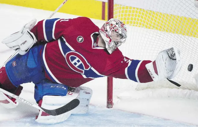  ?? Graham Hughes / THE CANADIAN PRESS ?? This sight was all too familiar for Montreal goaltender Carey Price on Sunday night in Game 2 of the Canadiens’ series with Tampa Bay.
The Lightning scored six times on Price, including this one by Nikita Kucherov. See story and more NHL playoff...