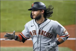  ?? TOM PENNINGTON/GETTY IMAGES ?? Brandon Crawford of the Giants celebrates after hitting a solo home run against the Texas Rangers on June 8 in Arlington, Texas.