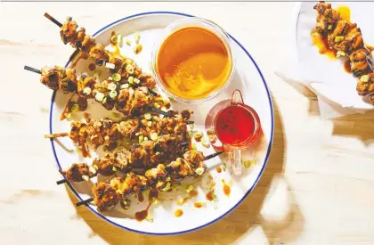  ?? PHOTOS: THE WASHINGTON POST ?? Grilled chicken skewers get a kick from a fiery sauce that embraces the five flavours of traditiona­l Chinese cooking.