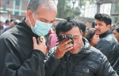  ?? PRAKASH MATHEMA / AGENCE FRANCE-PRESSE ?? Family members of a plane crash victim react outside a morgue at the Teaching Hospital in Kathmandu, Nepal, on Tuesday, a day after the deadly crash of a US-Bangla Airlines plane at the internatio­nal airport.