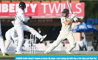  ??  ?? RANCHI: South Africa’s Theunis de Bruyn (R) plays a shot during the third day of the third and final Test match between India and South Africa at the Jharkhand State Cricket Associatio­n (JSCA) stadium in Ranchi yesterday. —AFP