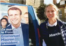  ?? — AFP ?? Emmanuel Macron’s stepdaught­er Tiphaine Auzière poses next to an electoral poster of Emmanuel Macron, prior to the distributi­on of leaflets in the streets of Le Touquet on Thursday.
