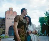  ?? ?? Newlywed stand-up comics Serhiy Lipko and Anastasia Zukhvala embrace Saturday on their wedding day in Kyiv. The army gave Lipko, soon to be deployed, a day off to tie the knot.