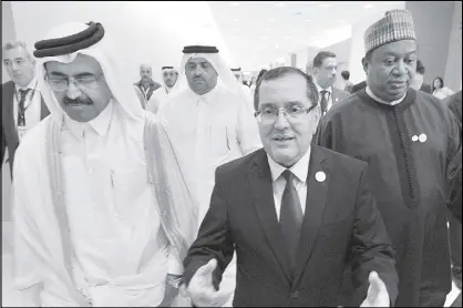  ??  ?? Algerian Energy Minister Noureddine Boutarfa (center) gestures as he leaves the Internatio­nal Conference Center in Algiers, Algeria with Minister of Energy and Industry of Qatar, Bin Saleh Al-Sada (left) and acting secretary general of OPEC Mohammed...