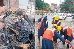  ??  ?? Drains and road blocks being cleared by the GHMC staff.