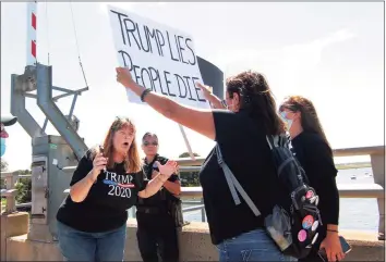  ?? Christian Abraham / Hearst Connecticu­t Media ?? A supporter of President Donald Trump, left, argues with a Black Lives Matter protester on the Devon Bridge during a Sept. 12 boat parade on the Housatonic River in Stratford.