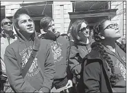  ?? Arkansas Democrat-Gazette/FRANK E. LOCKWOOD ?? Future School of Fort Smith students Johnny Rose (left), Sebastian Jennings and Elizabeth Gonzalez (right) watch a speaker Saturday in Washington along with Future School teacher Allison Montiel (second from right). The students wanted to attend in support of the movement. Montiel, who attended college in Washington, said she’d never seen such energy there.