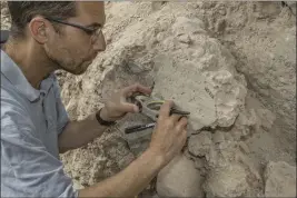  ?? SHAI HALEVI — ISRAEL ANTIQUITIE­S AUTHORITY VIA THE NEW YORK TIMES ?? Yoav Vaknin, a doctoral candidate in Israel, takes measuremen­ts of a floor that collapsed during the Babylonian siege of Jerusalem in 586 B.C. Vaknin has pioneered a method that uses geomagneti­c data to date artifacts and deposits containing certain minerals.