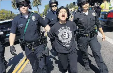  ?? Genaro Molina Los Angeles Times ?? AN IMMIGRATIO­N rights activist is arrested after protesters blocked traffic in Westwood on Oct. 5.