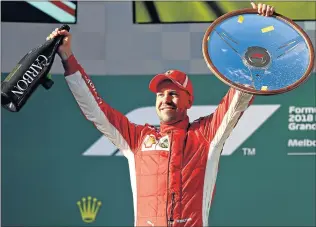  ?? Picture: GETTY IMAGES ?? FASTEST OF THEM ALL: Race winner Sebastian Vettel of Germany and Ferrari celebrate on the podium during the Australian Formula 1 Grand Prix at Albert Park, Melbourne yesteday