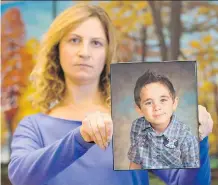  ?? JENN PIERCE/ CALGARY HERALD/ FILE ?? Layale Khalifeh holds a picture of her son, Jad, then age 7, in Calgary on Sept. 11, 2014.