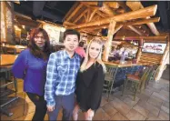  ?? Arnold Gold / Hearst Connecticu­t Media ?? From left, manager Valentina Coatanroch and owners Eddy Zheng and Sarah Belke pause in the newly opened Fireside Bar and Grill in Orange on Friday.