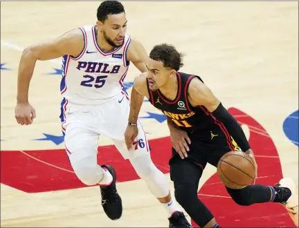  ?? MATT SLOCUM — THE ASSOCIATED PRESS ?? Atlanta Hawks’ Trae Young, right, tries to get past Philadelph­ia 76ers’ Ben Simmons during the second half of Game 7in a second-round NBA basketball playoff series Sunday in Philadelph­ia.