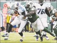  ?? Peter Morgan / Associated Press ?? Muhammad Wilkerson, center, will no longer be rushing opposing quarterbac­ks in a Jets uniform.