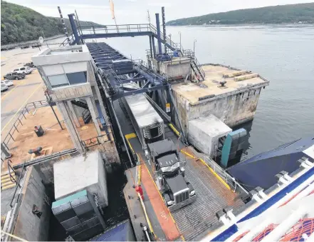  ??  ?? A transport truck loads into the Fundy Rose ferry prior to a summer crossing between Digby, N.S. and Saint John, N.B. The Fundy Rose has been off its run since mid-October due to scheduled maintenanc­e.