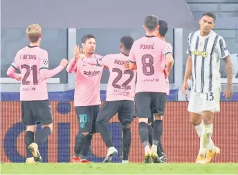  ?? — AFP photo ?? Messi (second left) celebrates scoring his team’s second goal during the UEFA Champions League Group G match between Juventus and Barcelona at the Juventus stadium in Turin.