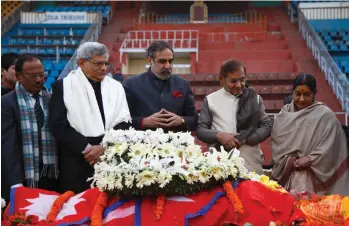  ?? — PTI ?? National security adviser Ajit Doval ( from left), CPI( M) secretary Sitaram Yechury, Congress leader Anand Sharma, JD( U) chief Sharad Yadav and external affairs minister Sushma Swaraj pay their respects near the body of Nepal’s former Prime Minister...