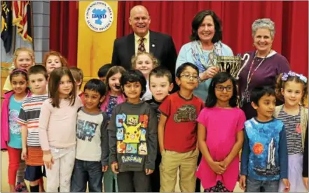  ?? SUBMITTED PHOTO ?? Downingtow­n Area School District Superinten­dent Lawrence Mussoline and health/phys ed teachers Lottie Adams and Carol Copeland pose with Shamona Creek Elementary School students to celebrate their school receiving the award for best mascot in the...