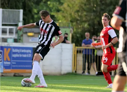  ?? PICTURES: Simon Howe ?? Bath City’s Coady Cooke nets against Exeter City as former Bath loanee Alex Hartridge looks on