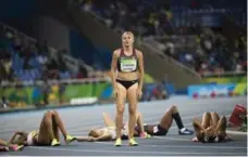  ?? LUCAS OLENIUK/TORONTO STAR ?? Lucas Oleniuk won Sports Photo of the Year for this photo of Brianne Theisen-Eaton standing above her Olympics competitor­s.