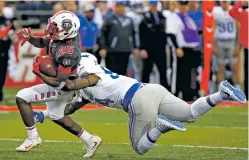  ?? ANDRES LEIGHTON/ASSOCIATED PRESS FILE PHOTO ?? Lobos running back Tyrone Owens is tackled by Air Force defender Jordan Jackson last month in Albuquerqu­e. UNM led the country in rushing last season, but is on pace to pass for more than 700 yards than it had a year ago.